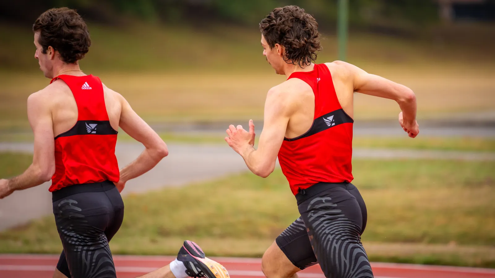 a couple of men running on a track