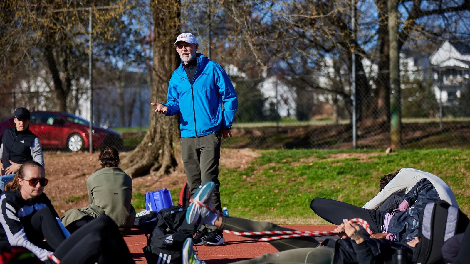 a person standing on a trampoline with people sitting around