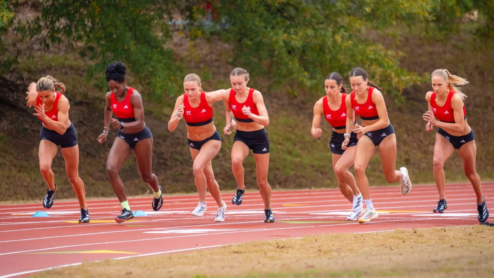 a group of people running on a track