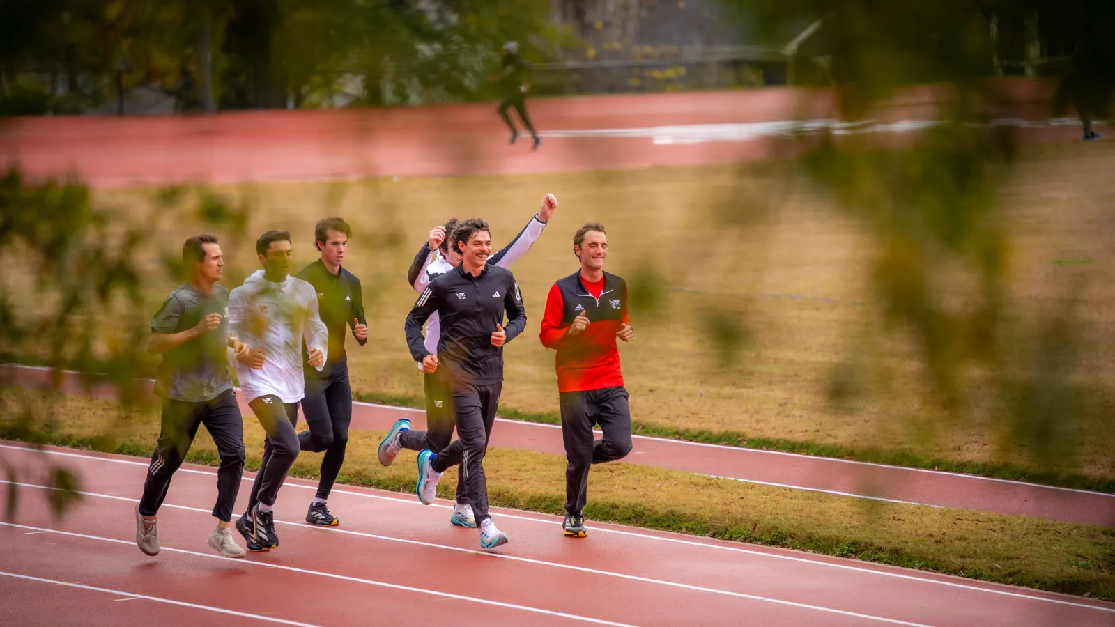 a group of people running on a track