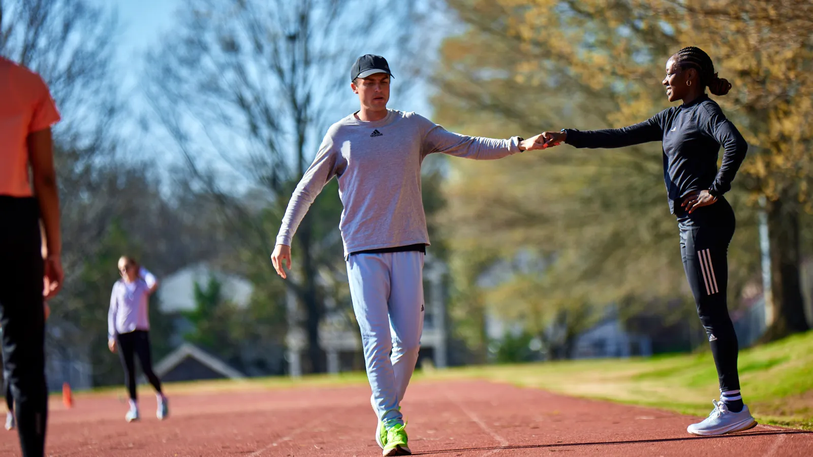 a man and a woman running on a track