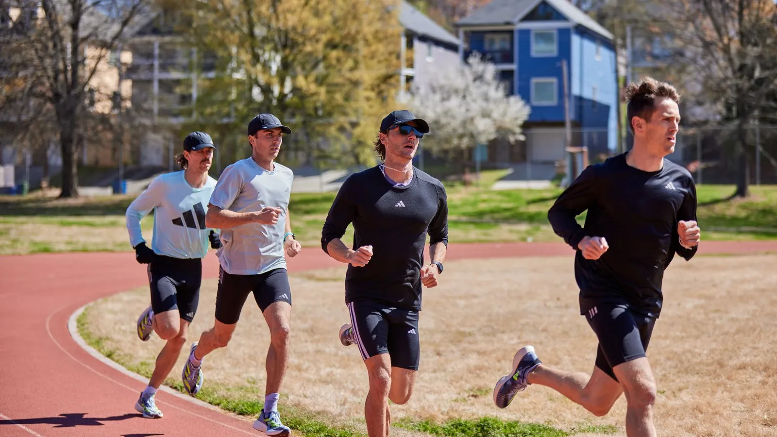 a group of men running on a road