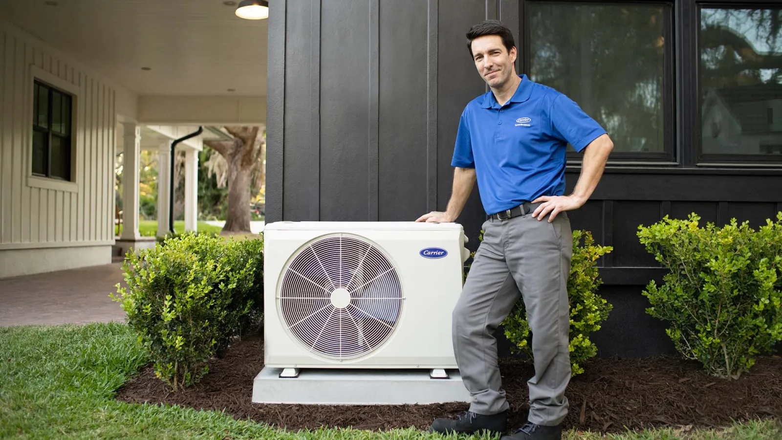 a person standing next to a fan