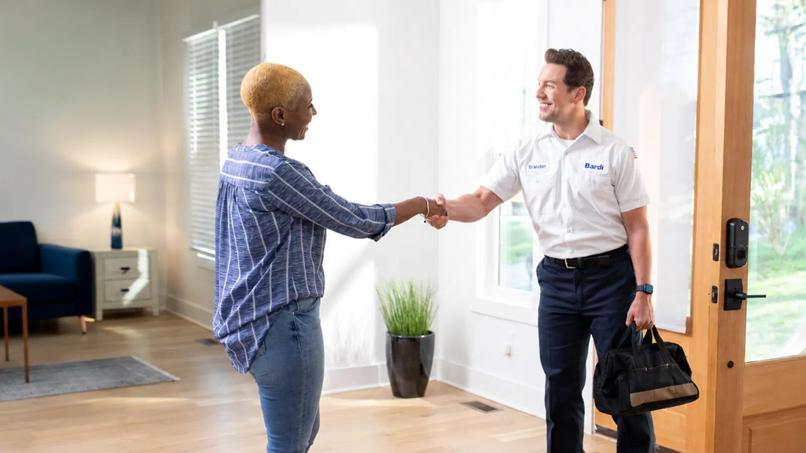 Bardi technician greeting a homeowner during residential HVAC, plumbing, and electrical service in Metro Atlanta