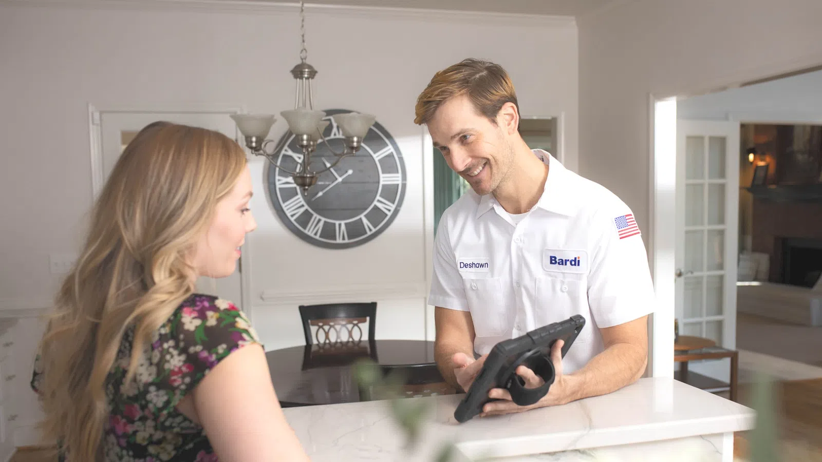 a man and a woman looking at a tablet