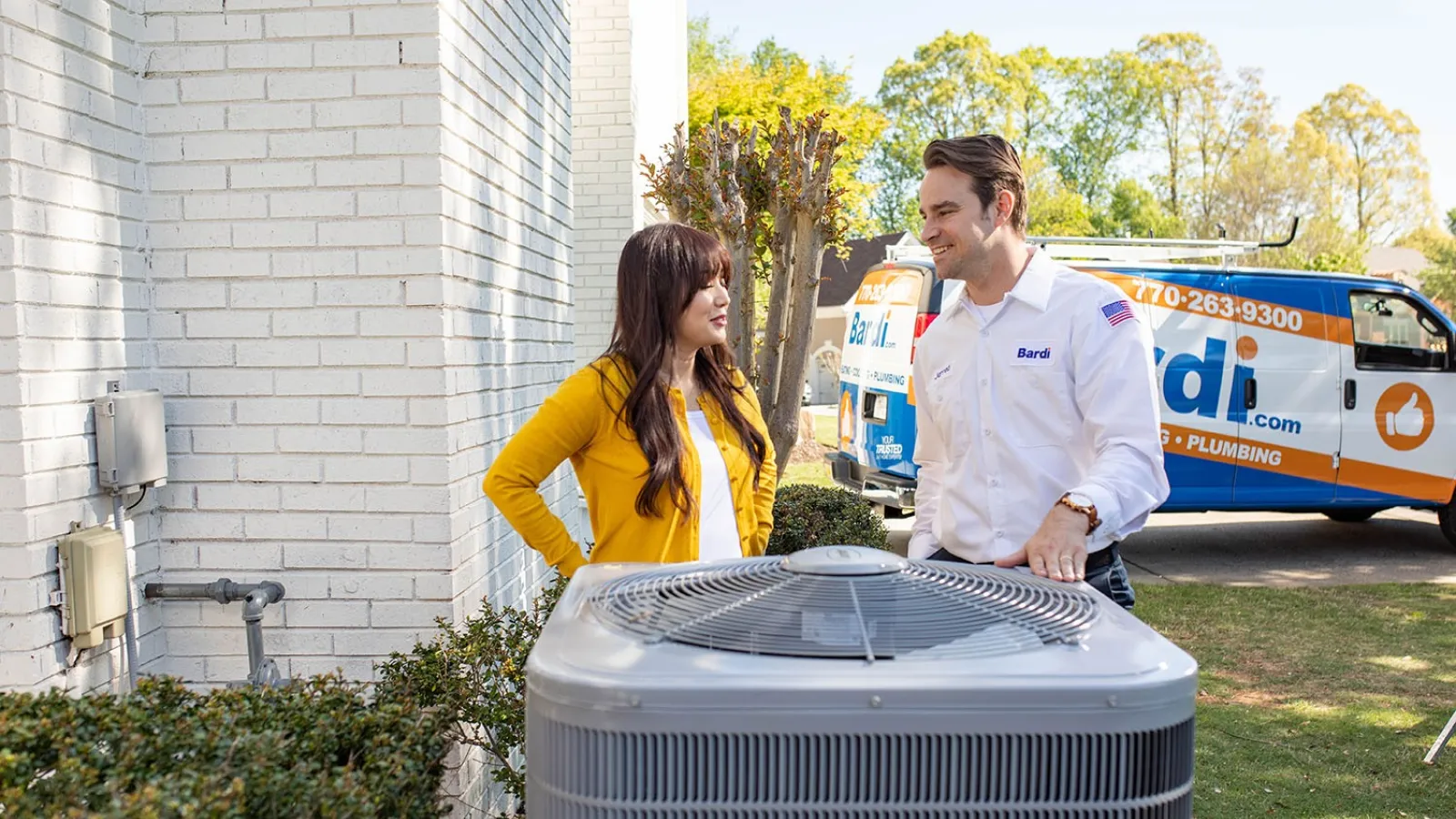 a man and a woman standing next to a car