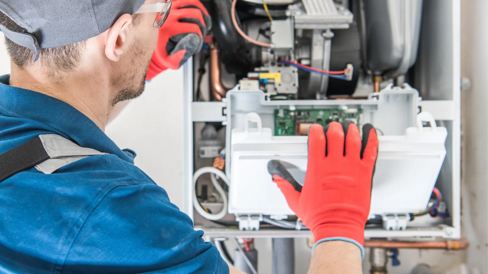 a man repairing a furnace