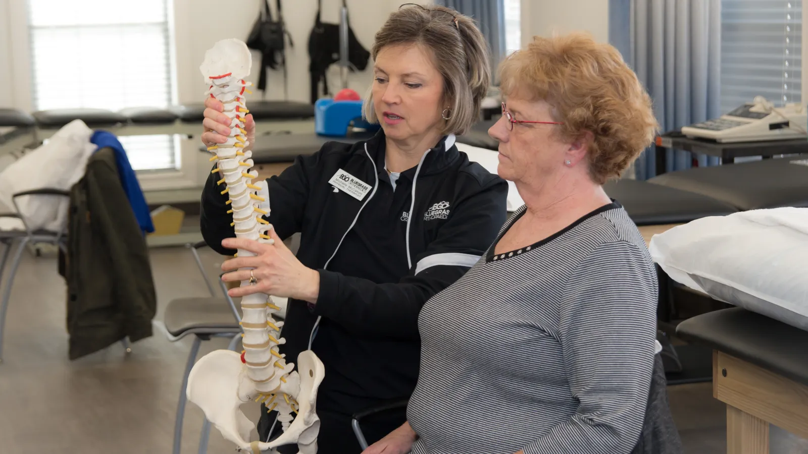 a woman assisting patients with physical therapy