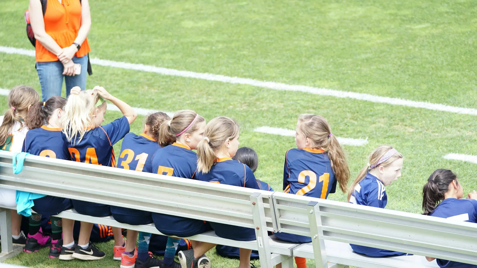 a group of girls sitting on a bench