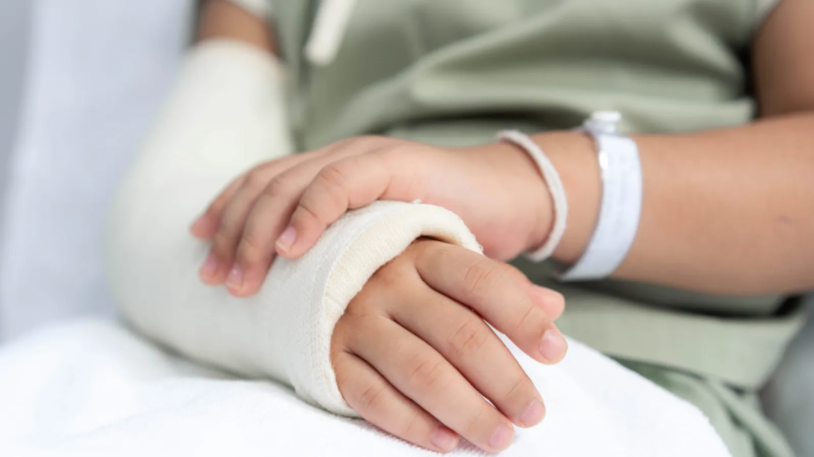 a close-up of hands holding a white ball