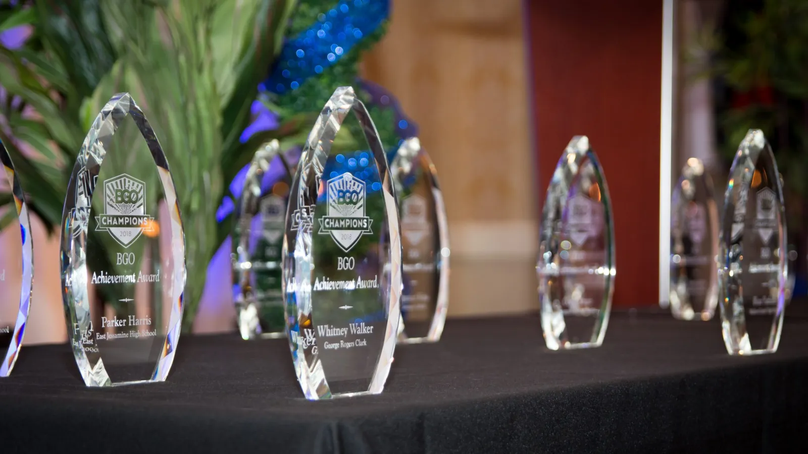 a group of glass awards on a table