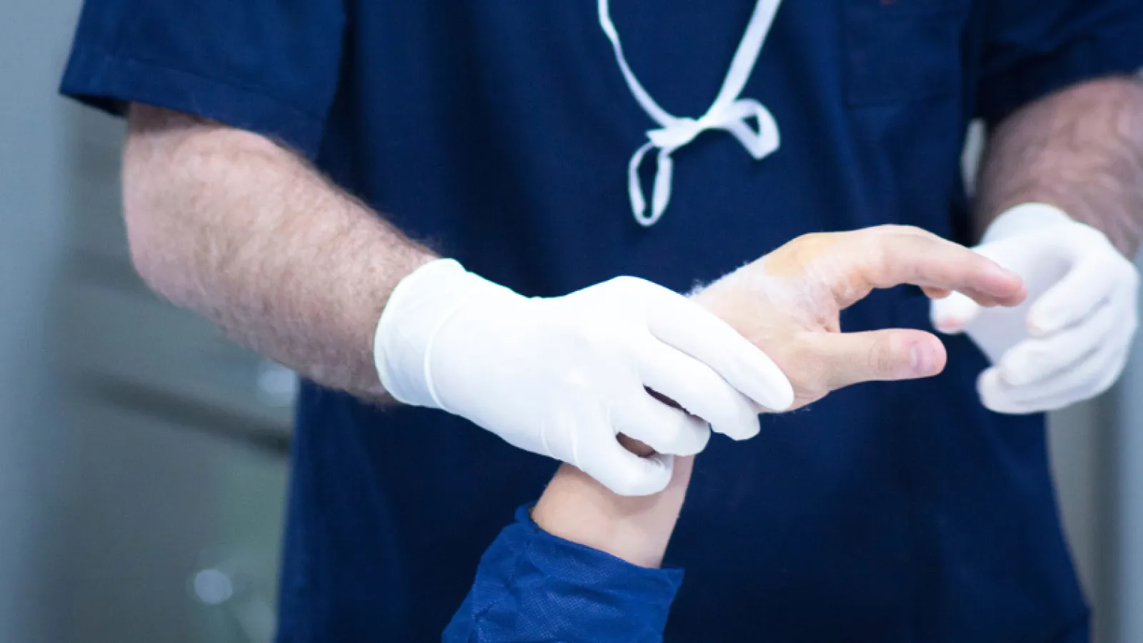 a close-up of a man wearing gloves