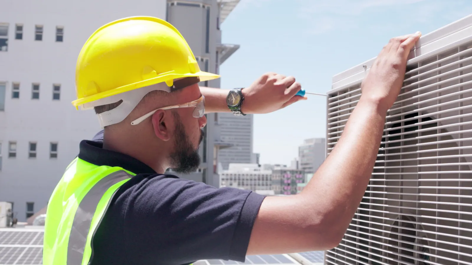 hvac technician servicing a commercial hvac unit