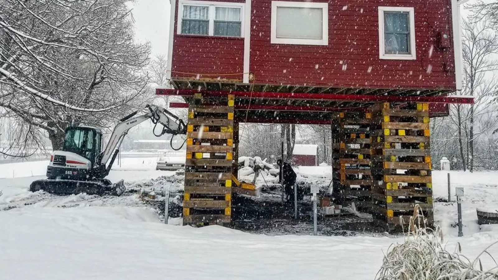 a red house with a crane in the front