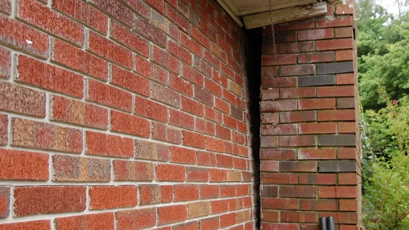 a brick wall with a pipe