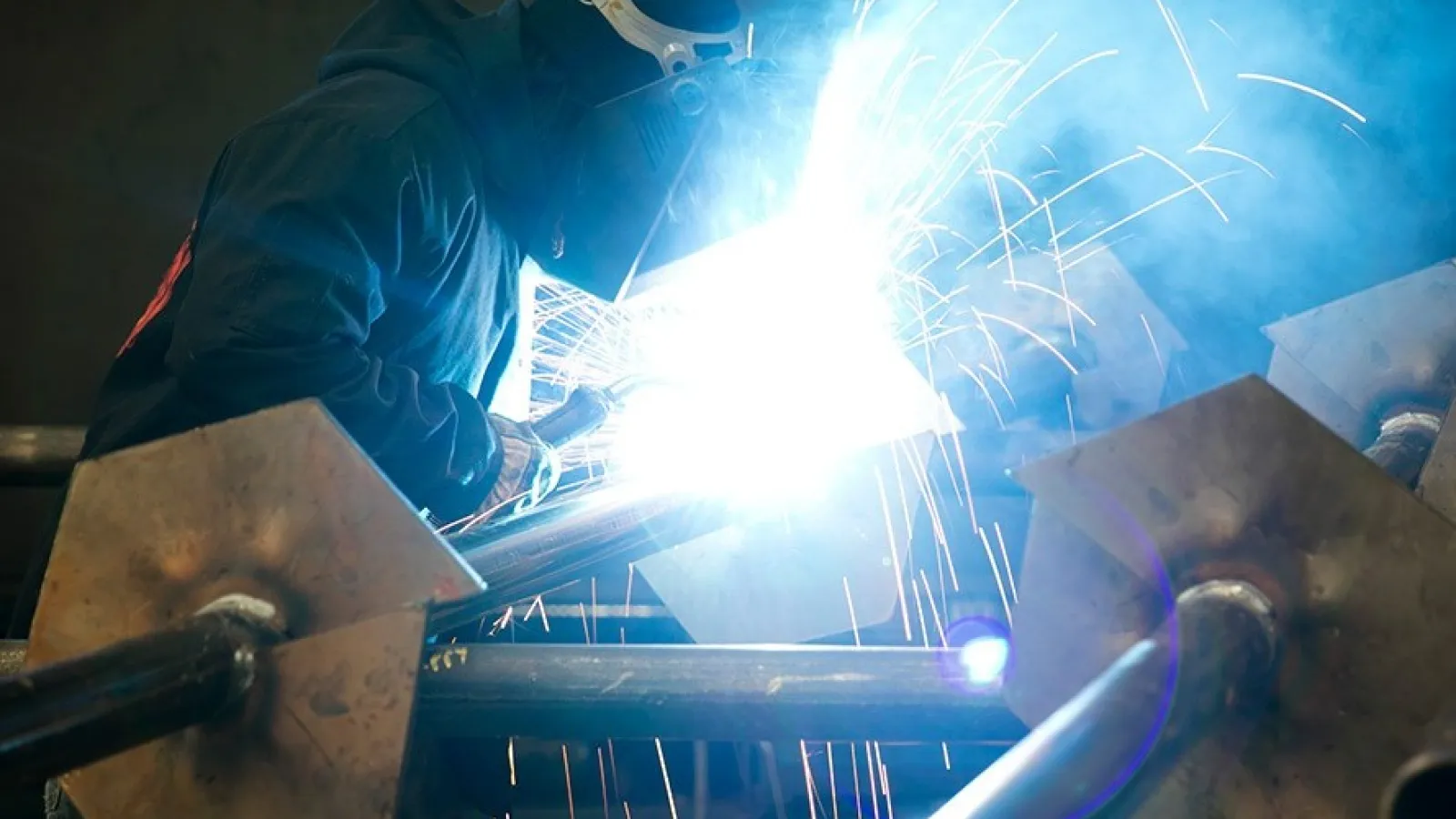 a person welding with sparks