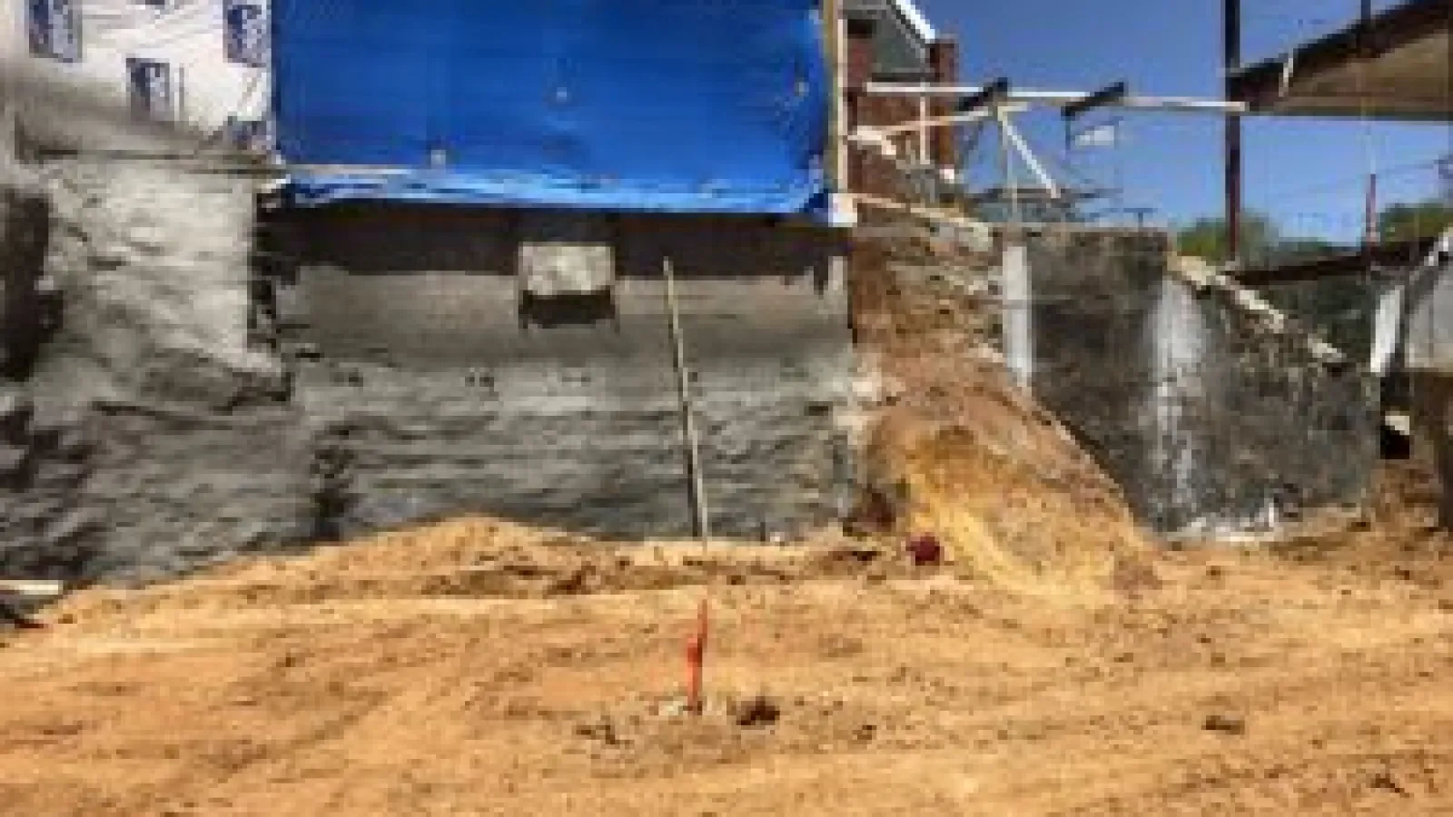 a construction site with a blue tarp