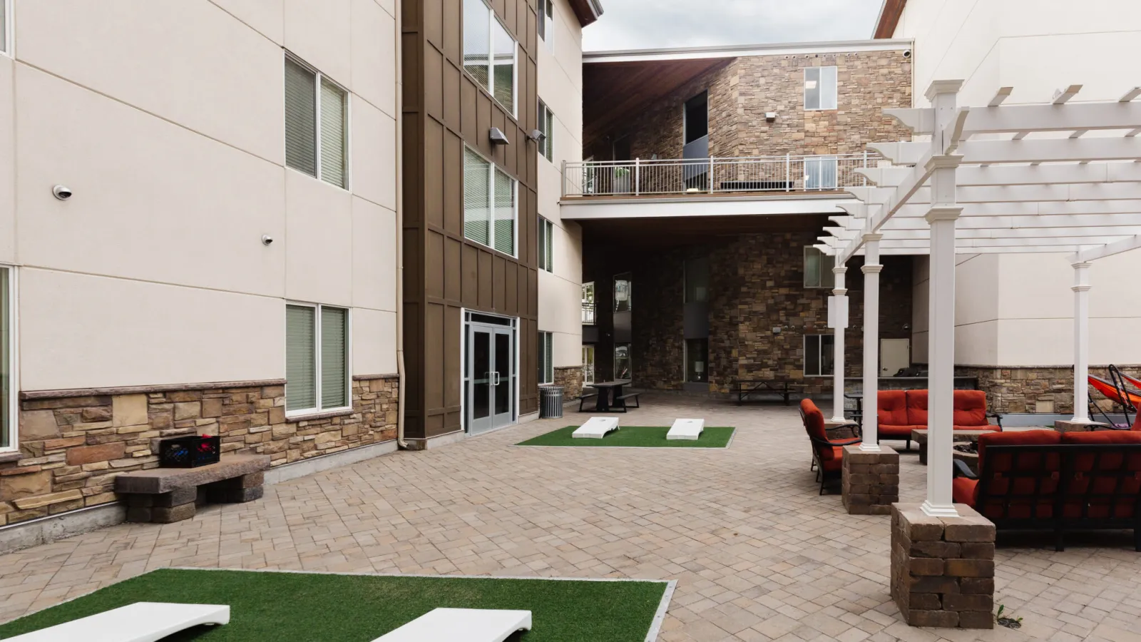 a courtyard with a pool and chairs