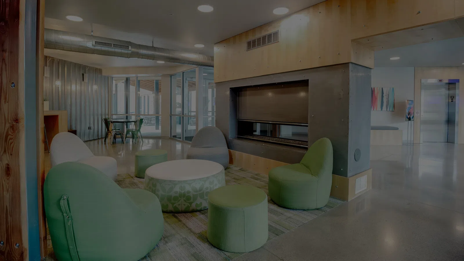 a room with green chairs and a table