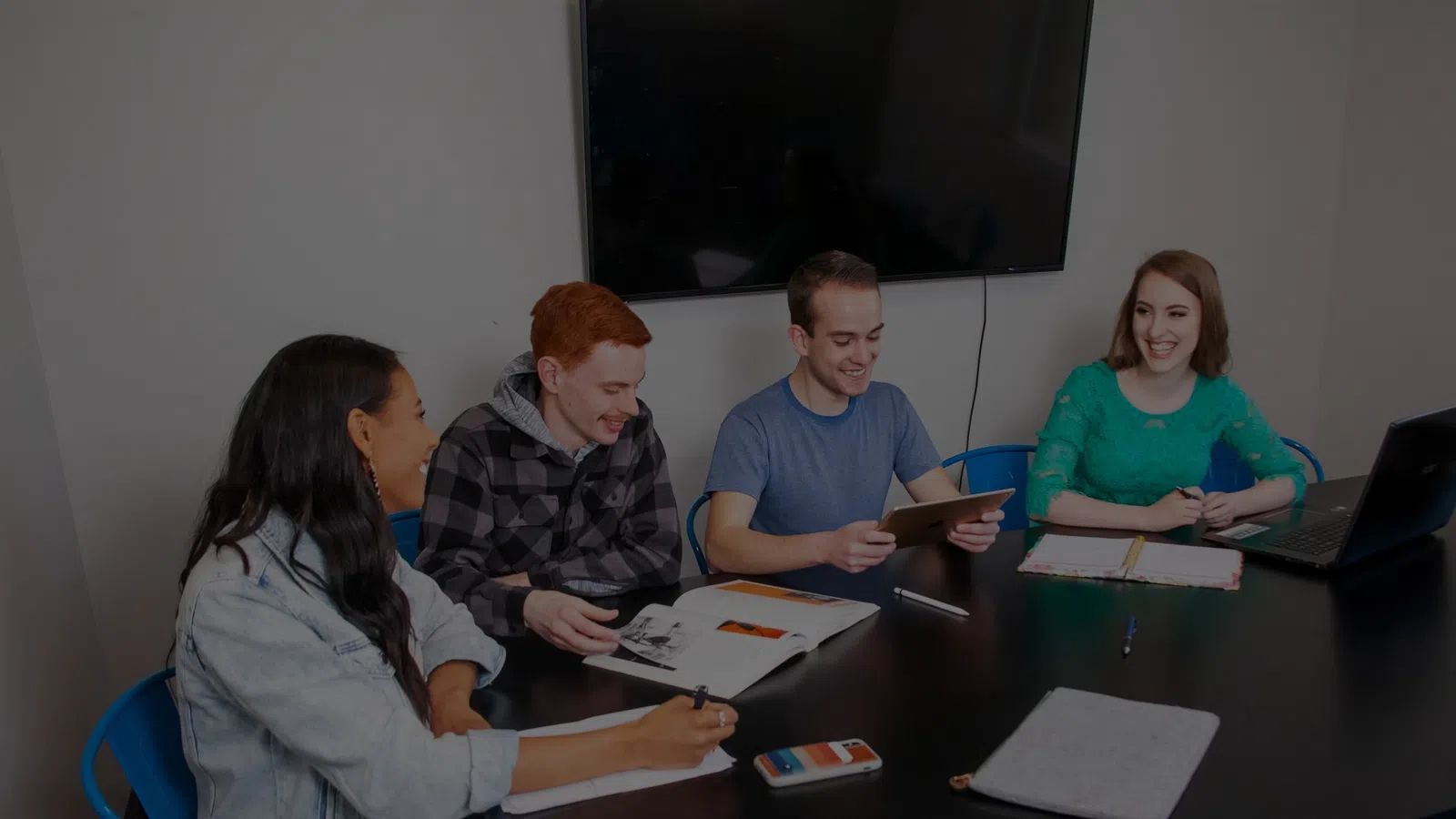 a group of people sitting around a table