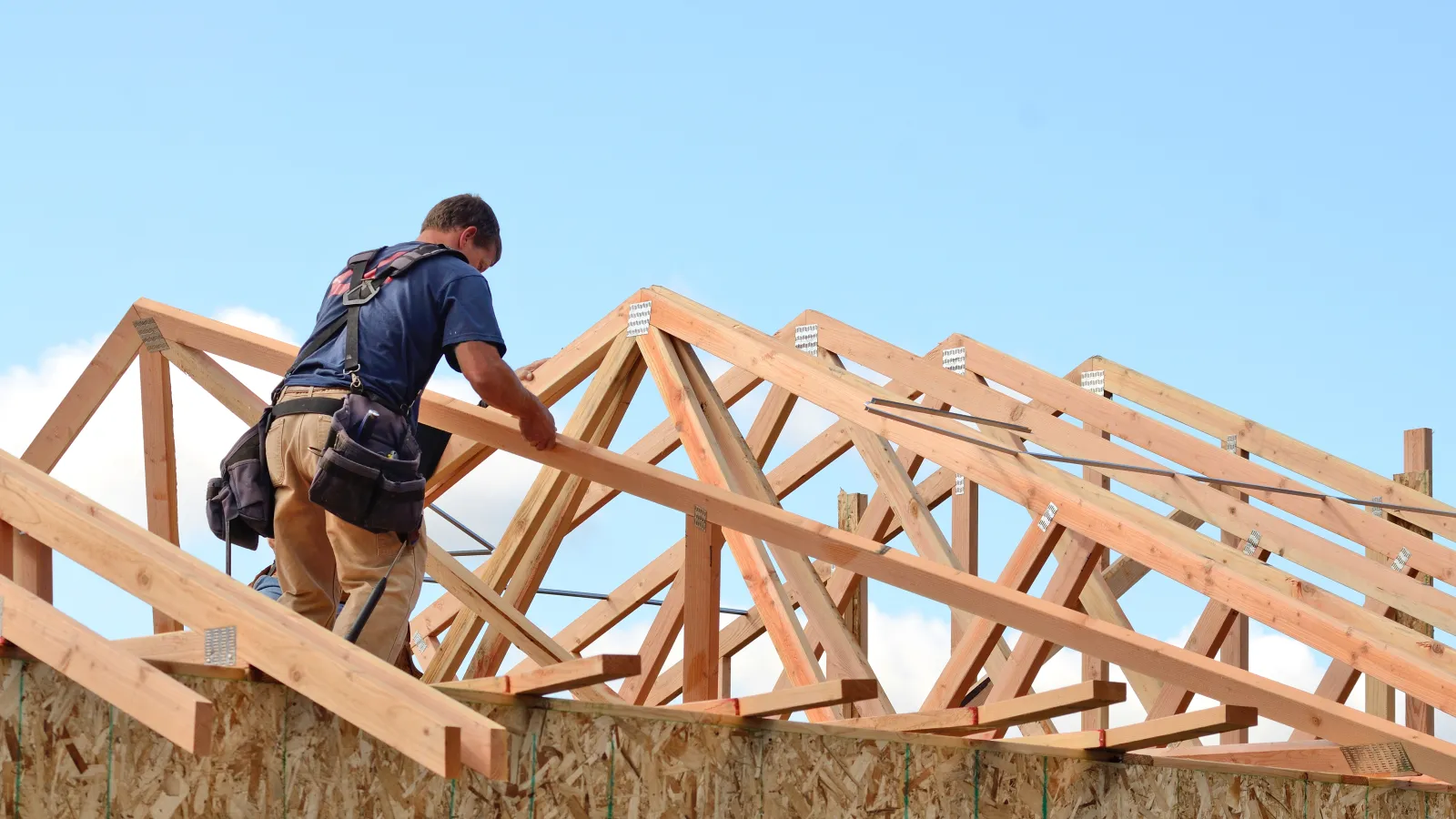 a man climbing a wooden fence
