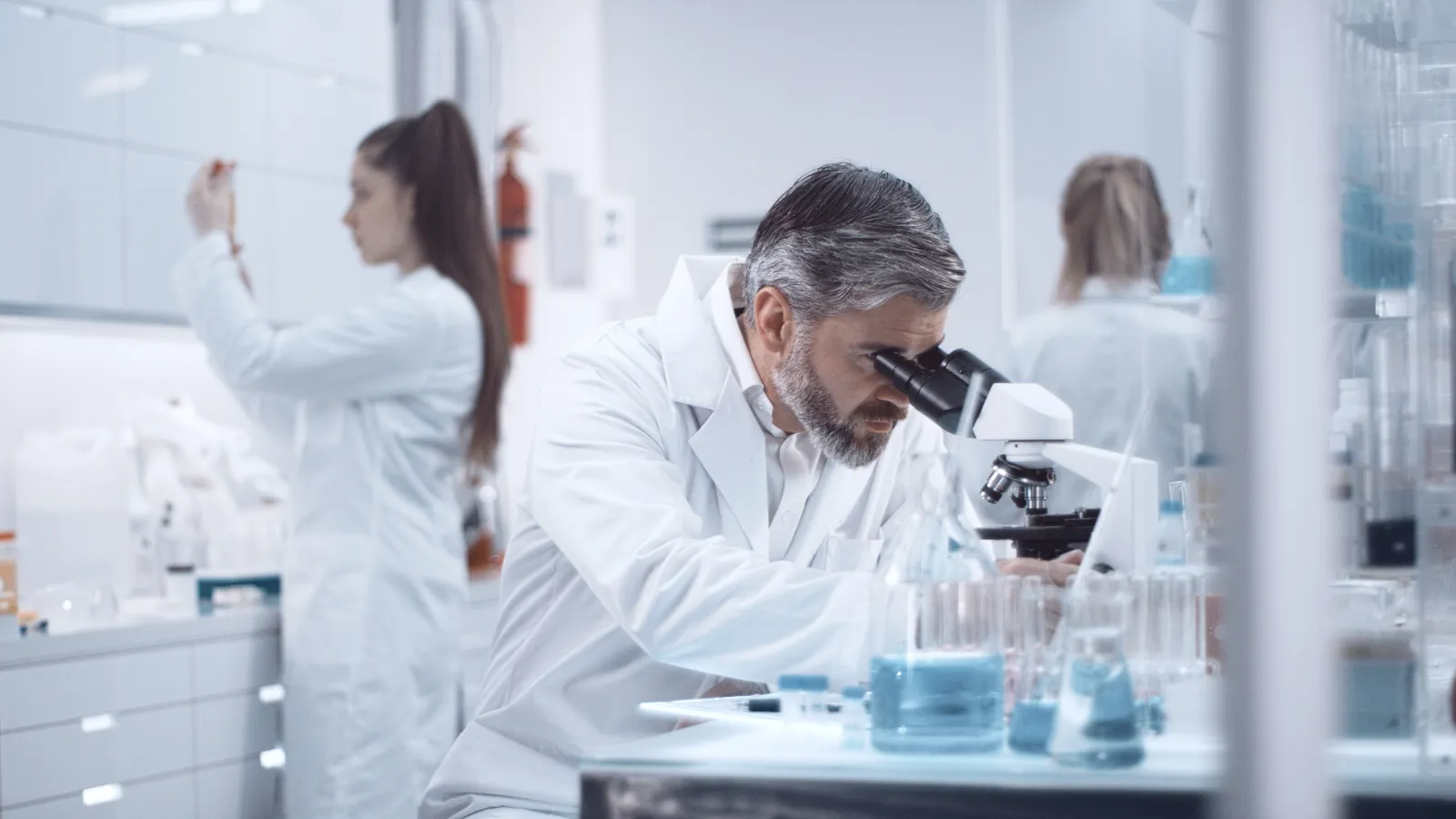 a woman looking at a microscope