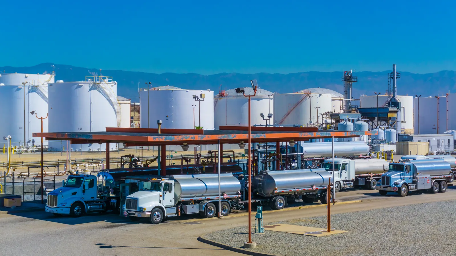 trucks parked in front of a factory