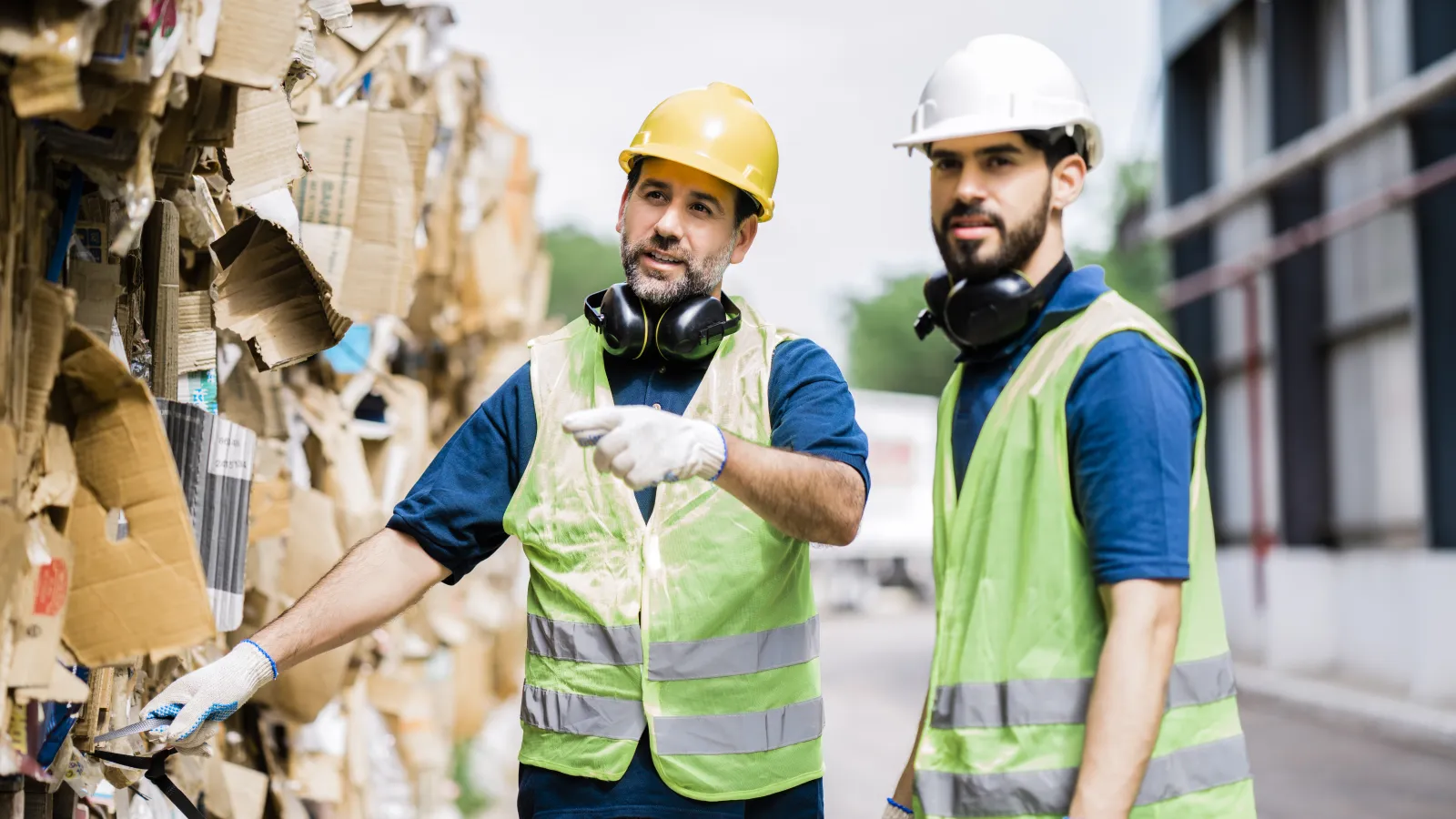 a few men wearing hardhats and reflectors