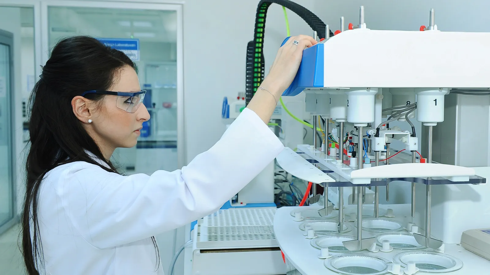 a person in a lab coat holding a magnifying glass