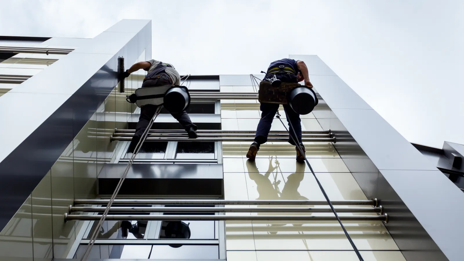 a few people climbing a building