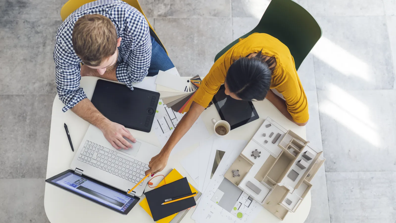 a few men working on a laptop