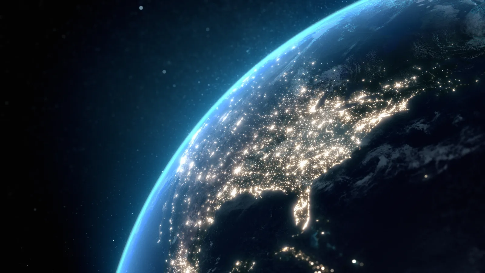View of Earth from space showing city lights glowing across the eastern United States at night.