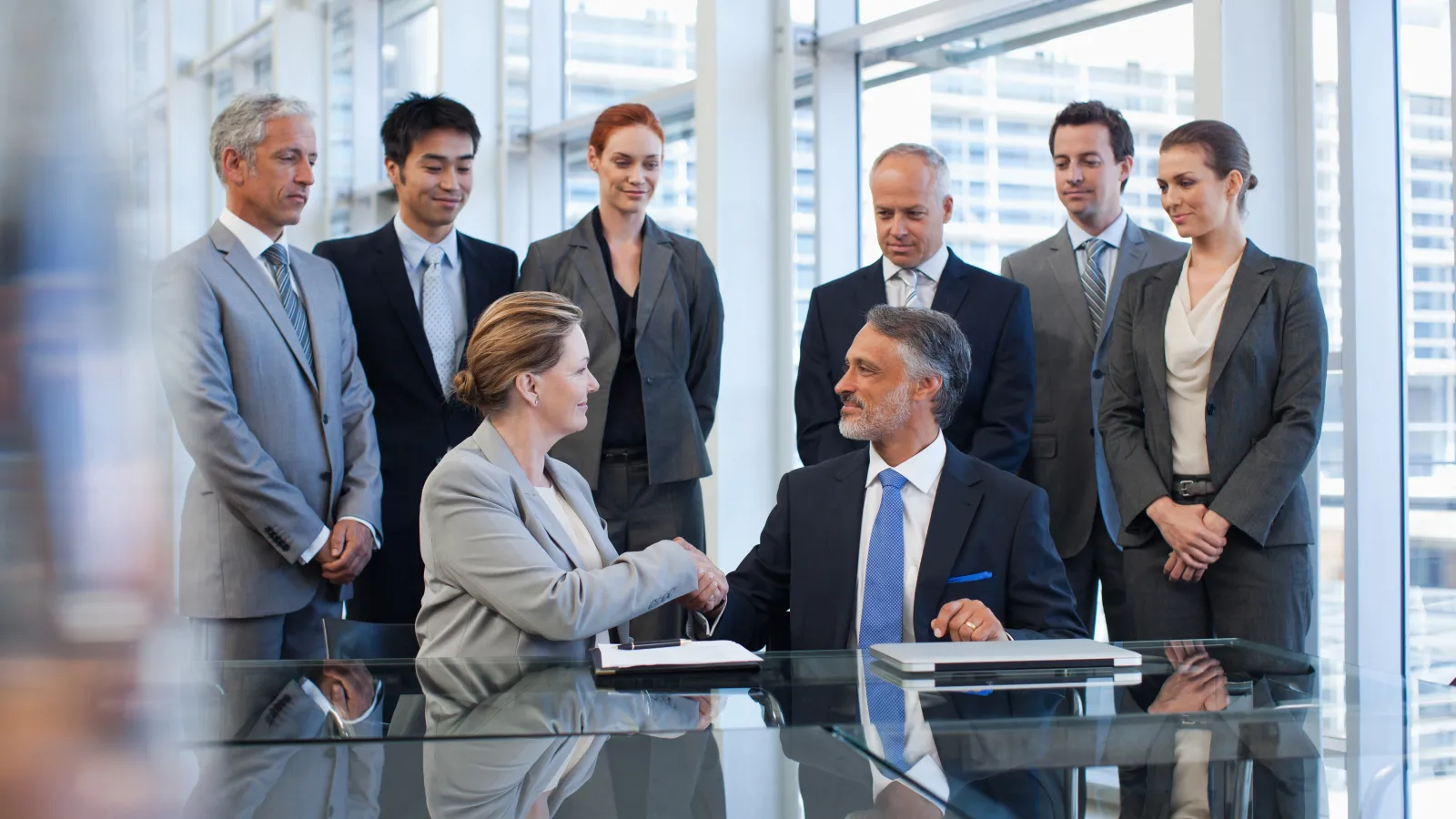a group of people standing around a table