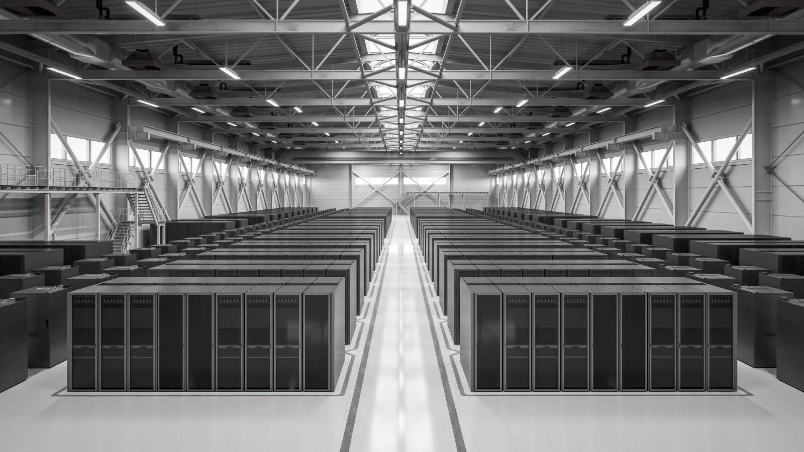 Modern data center interior with rows of server racks under industrial ceiling lighting and skylights.
