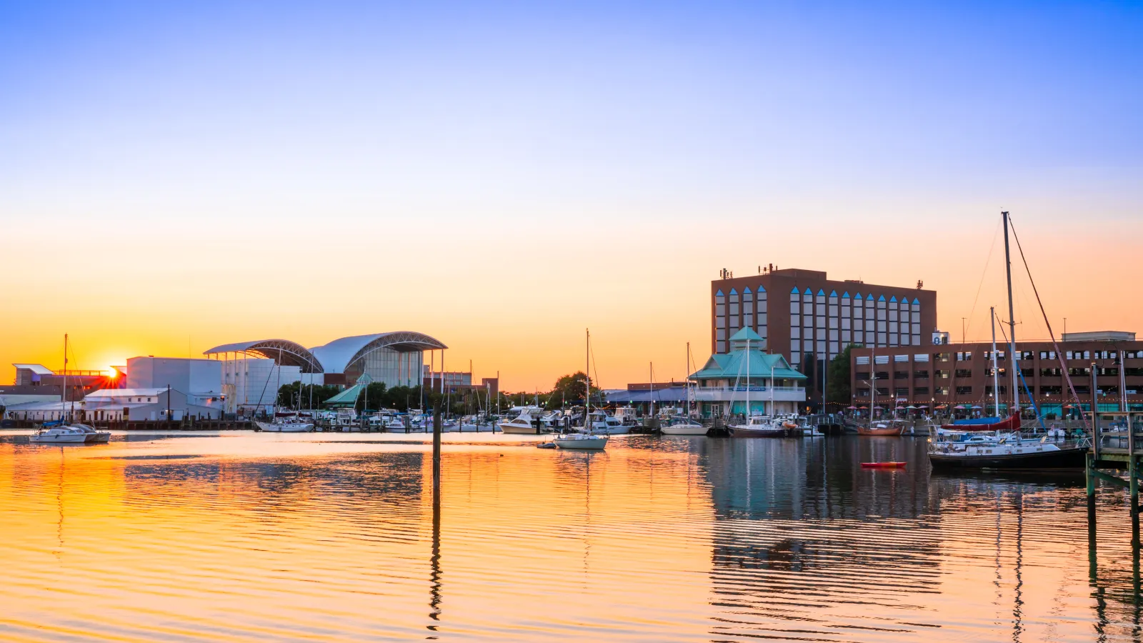 a body of water with boats and buildings along it