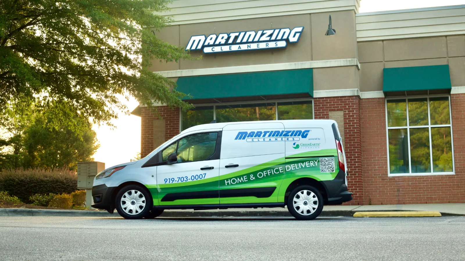 a green and white van parked outside a building