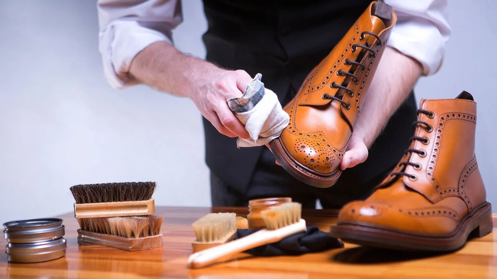 a person wearing gloves and holding a gavel over a pile of coins