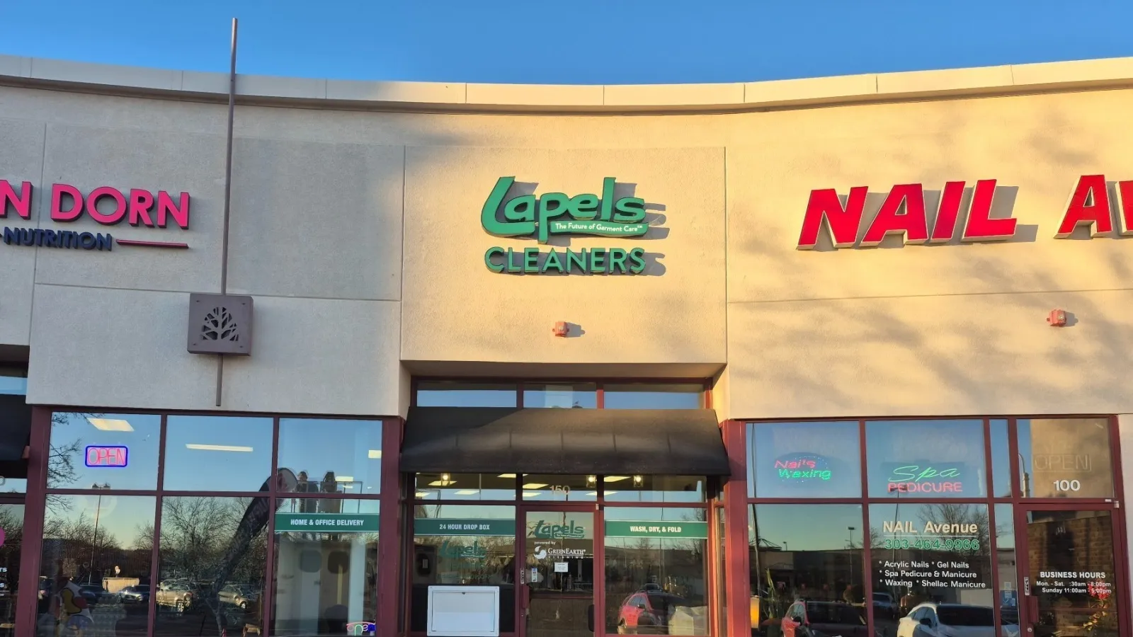 a couple of men standing in front of a building