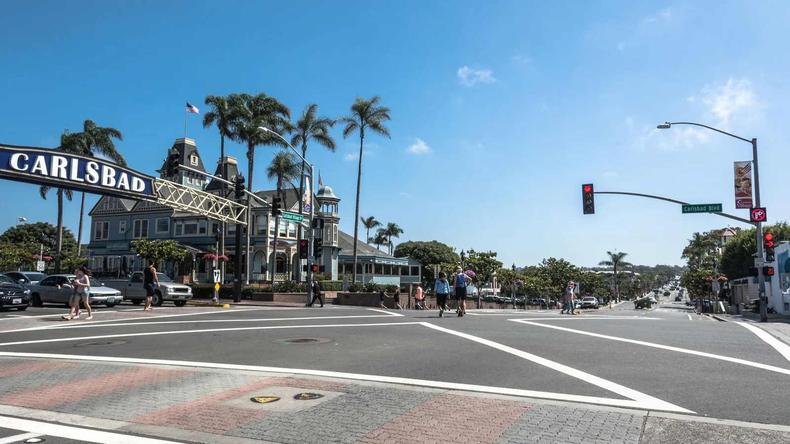 a street with palm trees and people