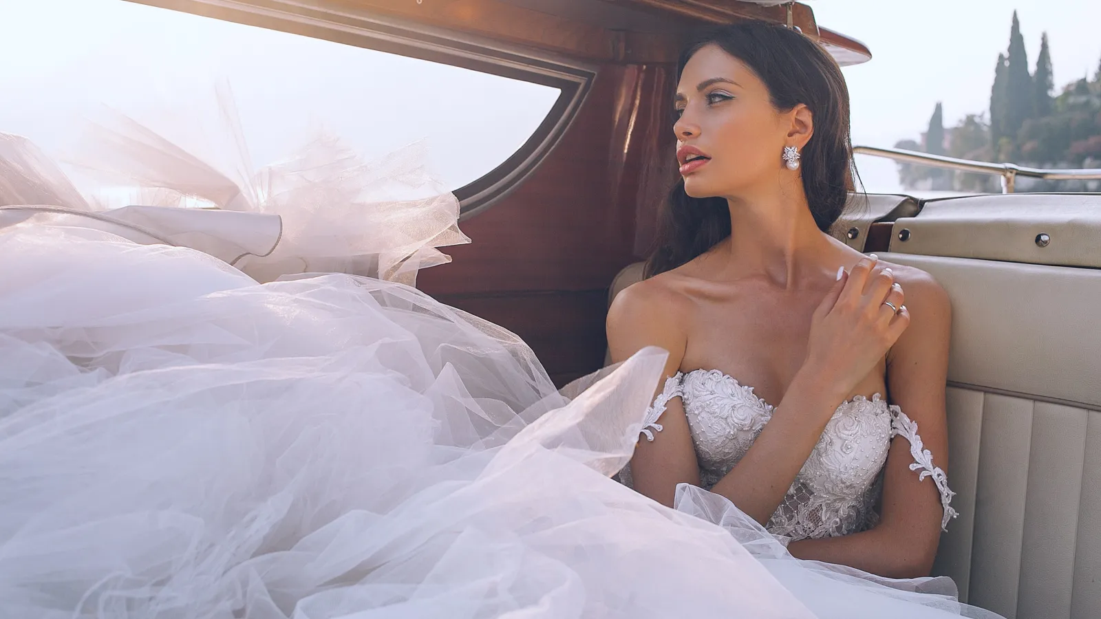 a woman in a white dress in a car