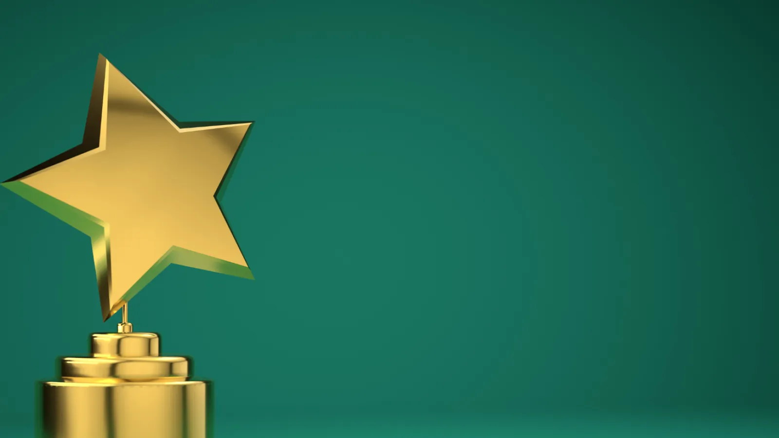 Golden star trophy on a reflective surface against a green background symbolizing achievement and excellence.