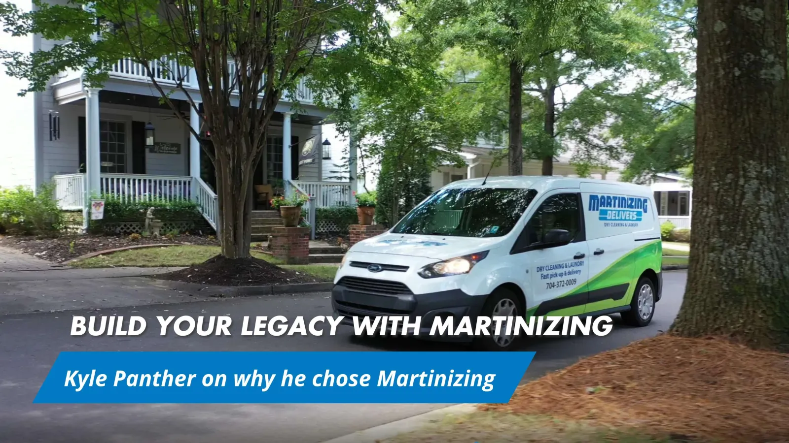 White Martinizing delivery van parked on a residential street in front of a house with trees and landscaping.