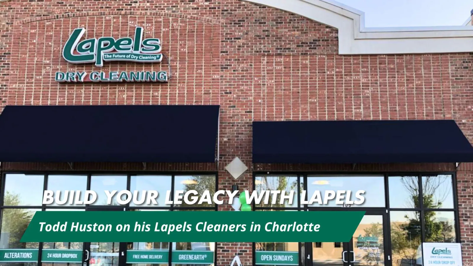 Exterior of Lapels Dry Cleaning store in a brick building with signage and promotional banner about legacy and location.