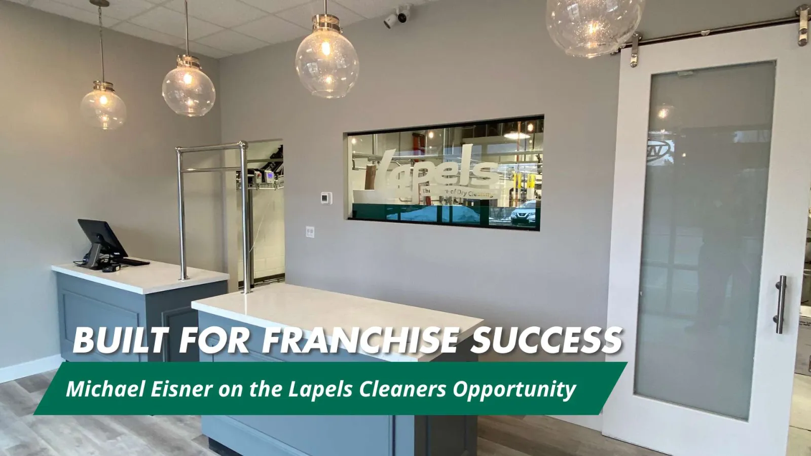 Modern Lapels Cleaners store interior with counter, hanging lights, and branding window in clean design.