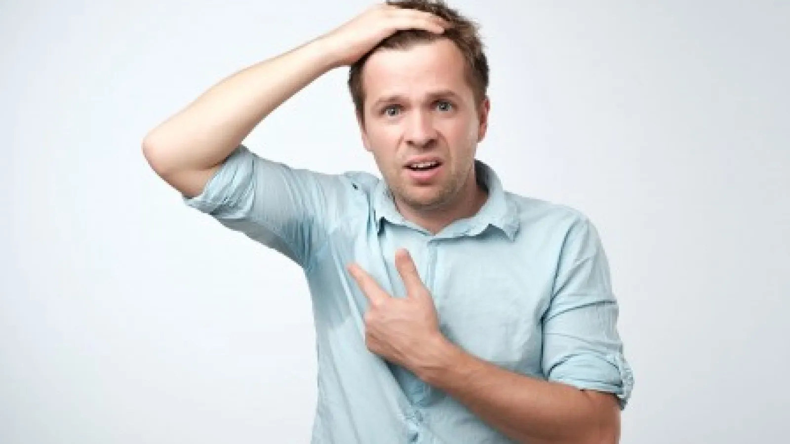 a man with his hand on his head