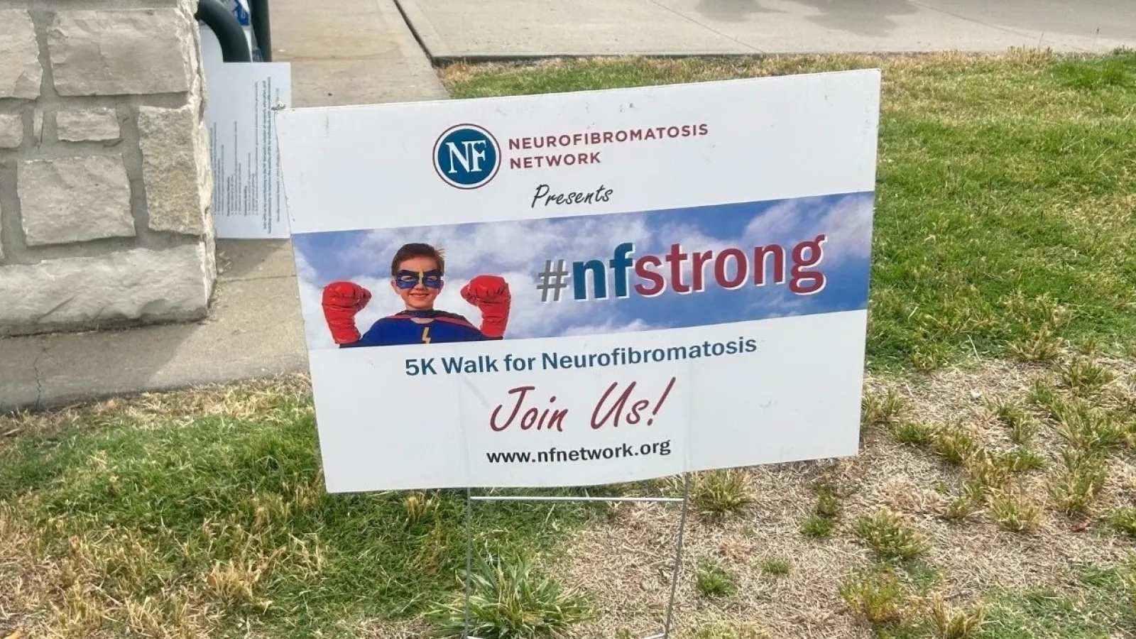 a sign on the grass