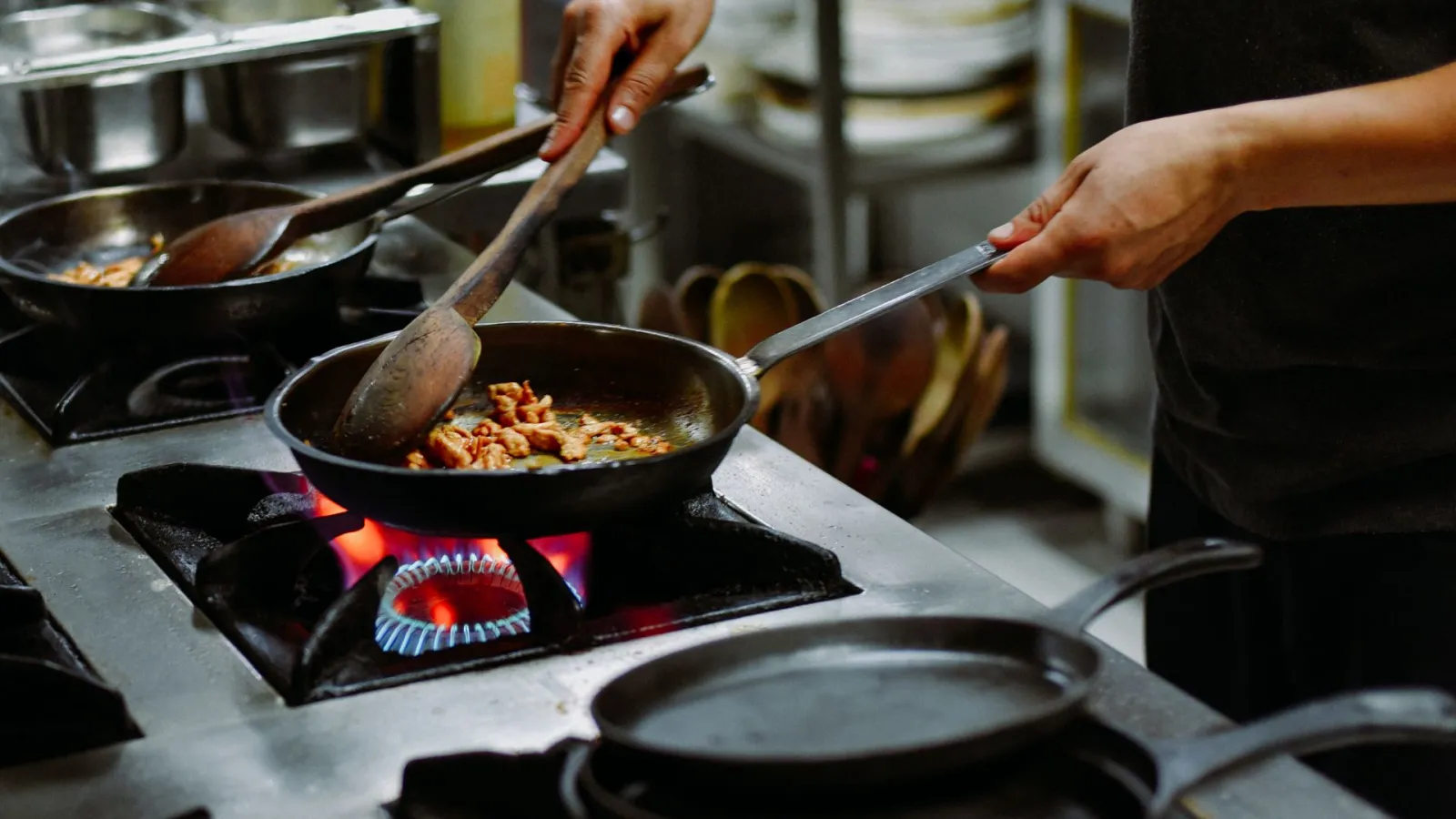 a person cooking food on a stove