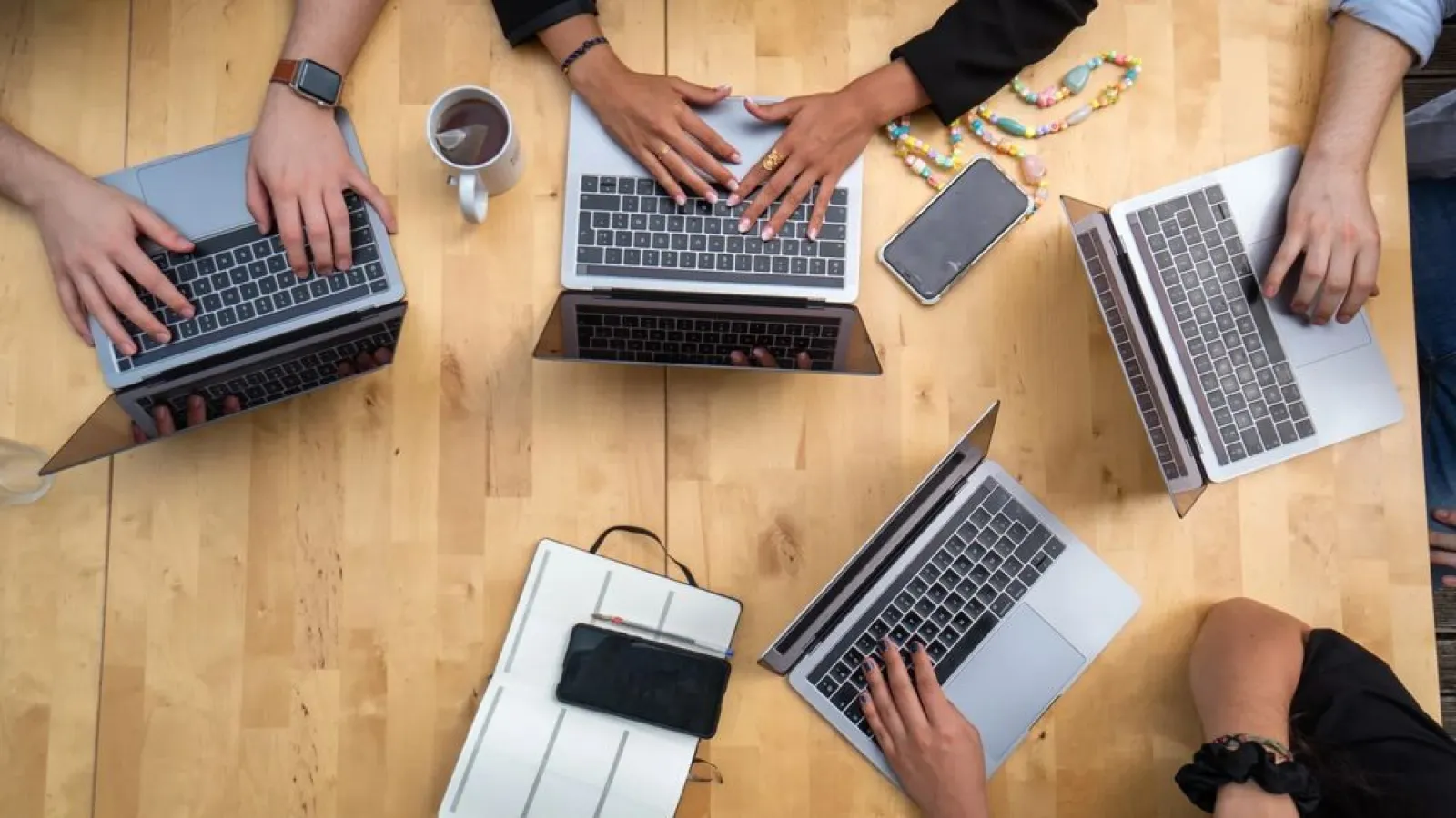 a group of people using laptops