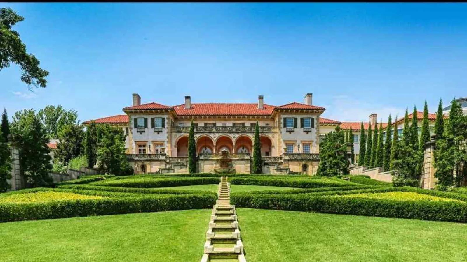 a large house with a lawn in front of it with Philbrook Museum of Art in the background