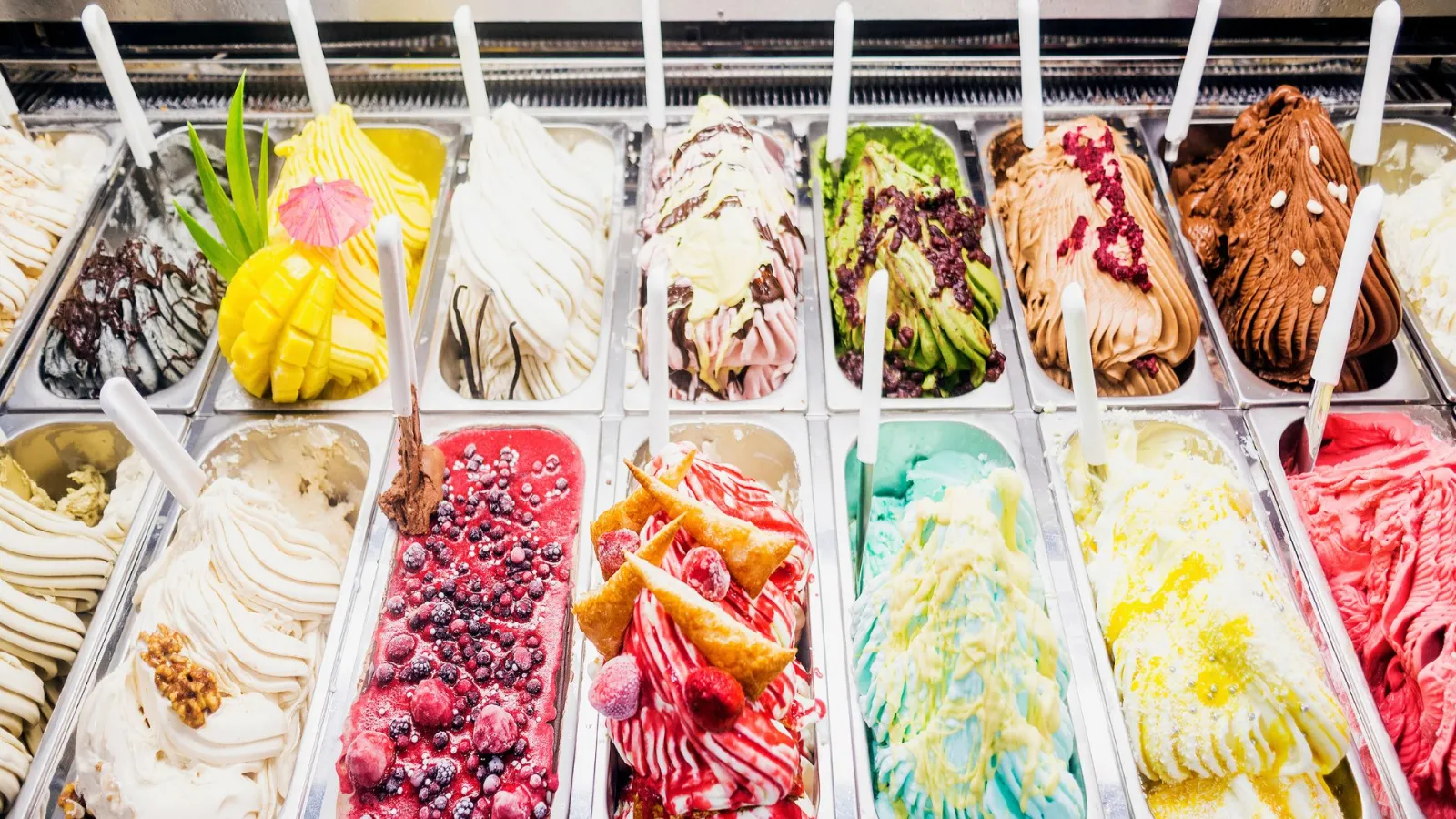 a group of different types of ice cream in plastic containers